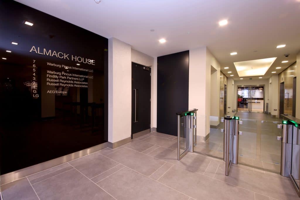 2B4A0558 Refurbished corporate lobby at Almack House featuring sleek black wall directory signage, modern finishes, and clear company floor listings—ideal showcase of high-end commercial entrance fit out.