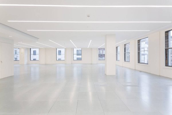 1-29 Refurbished office space with smooth tiled flooring, large windows maximizing natural light, and integrated smart lighting for energy efficiency and comfort.