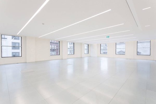 1-35 Open office layout featuring high-performance secondary glazing, underfloor air conditioning vents, and streamlined LED ceiling lights for a modern aesthetic.