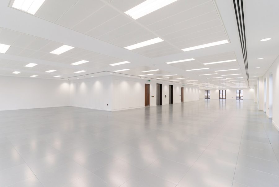 Large refurbished workspace featuring modern ceiling panels, upgraded LED lighting, newly installed flooring, and enhanced window detailing.