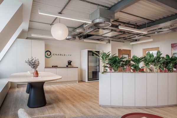 Open-plan CAT B fit out featuring collaborative meeting table, integrated planting, exposed MEP services and contemporary workplace design.